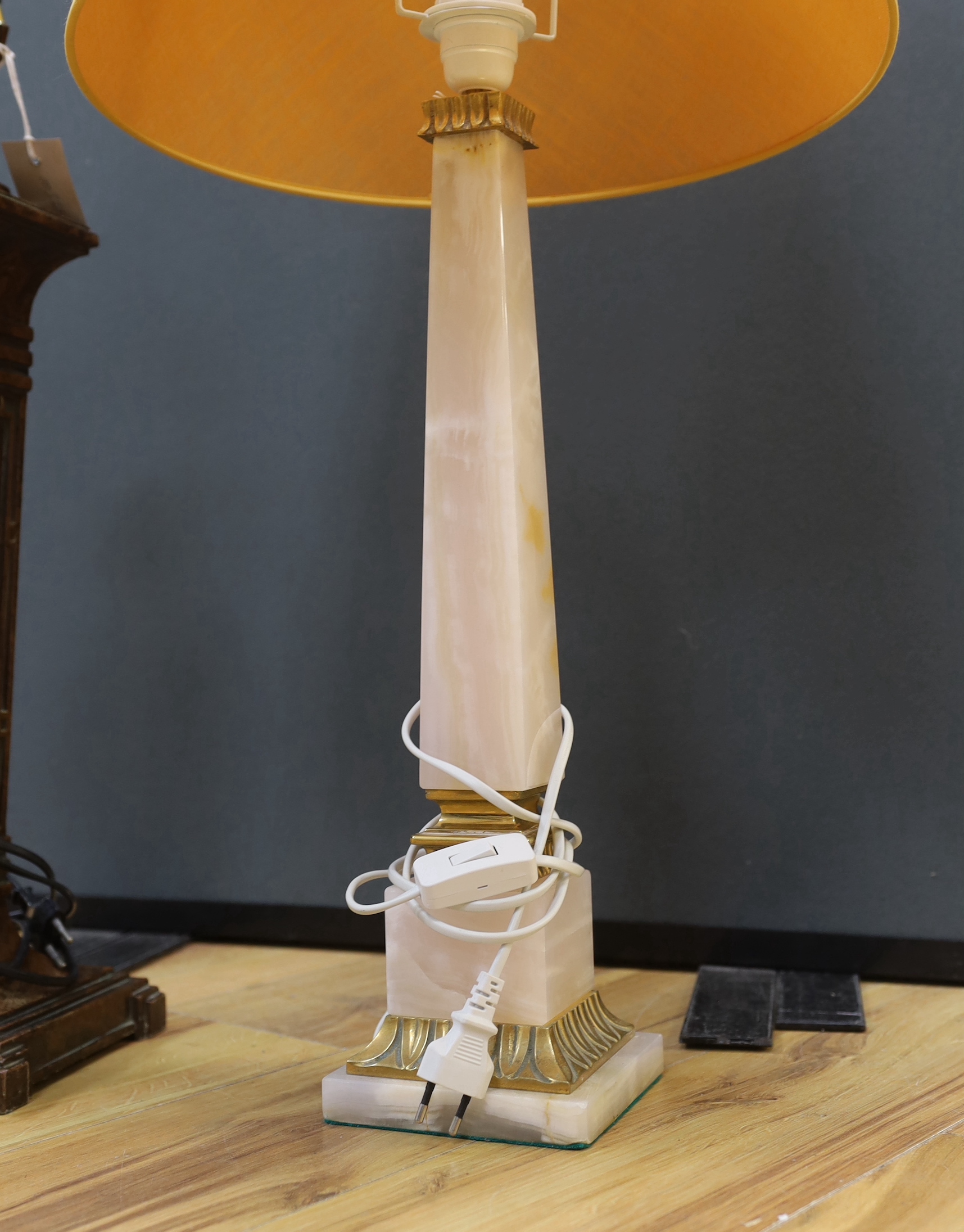 Two Art Deco style lamps comprising a spelter example and an onyx example, the largest 54cm excluding the fitting
